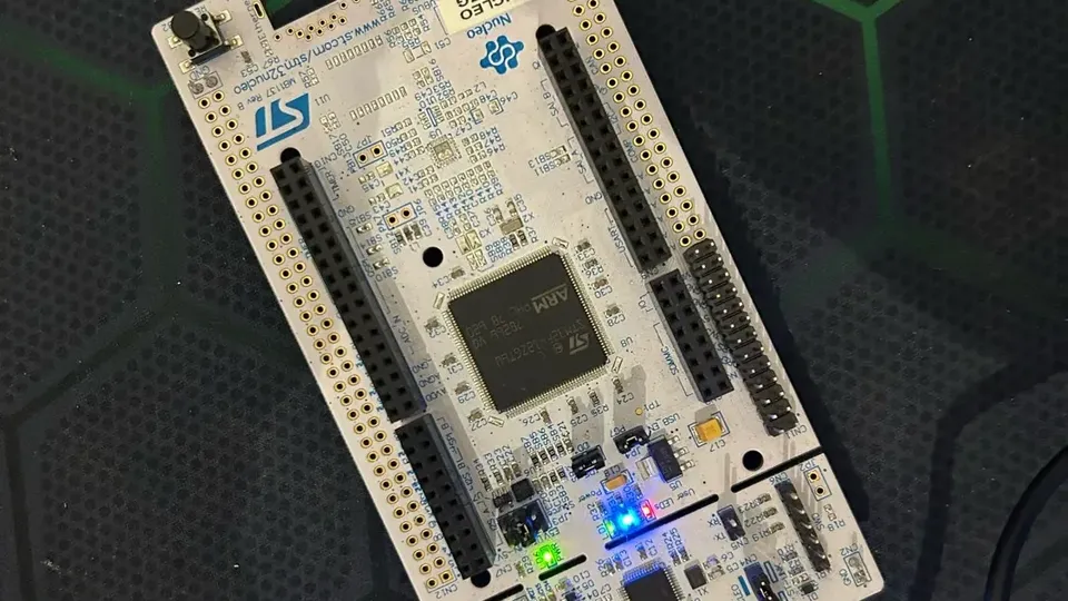 The NUCLEO-F412ZG board plugged in over USB, its green, blue and red LEDs lit.